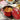 Zwilling Cast Iron 5-qt Tall Cocottes Lifestyle Image 2 a set of two Zwilling Cast Iron 5-qt Tall Cocottes in rich red for elegant meal presentations.