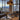 Graypants Kerflights Drum Pendant Light Lifestyle Image 1 this image is showing the pendant light hanging from the ceiling in a room with a city view.