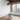 Graypants Scraplights Dome Pendant Light Lifestyle Image 2 this image is showing the pendant light hanging from the ceiling in a clean room with an office chair.