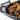 Staub Cast Iron 14.5"X 11.2" Oval Baking Dish Lifestyle Image 1 shows that this product is ideal for casseroles and hearty dishes.