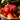Staub Ceramic 16-oz. Petite Tomato Cocotte - Cherry Lifestyle Image 2 shows a delightful tomato-shaped ceramic dish in rich cherry red, ideal for single servings.